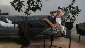 sick person lying on couch