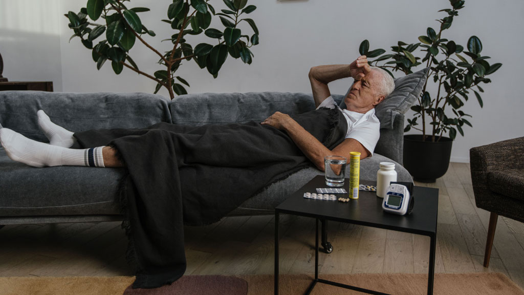 sick person lying on couch
